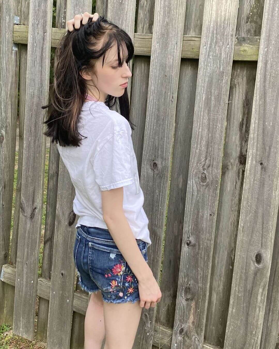 A teenage girl in embroidered short shorts